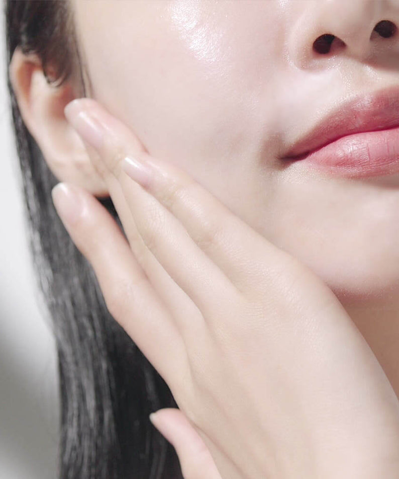 Woman applying PYUNKANG YUL Calming Sun Cream SPF+PA++++ 50ml for skincare