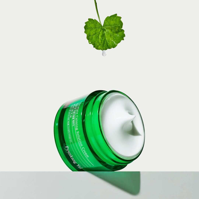 PYUNKANG YUL Ultimate Soothing Solution Cream 30ml with fresh green leaf above for gentle skincare