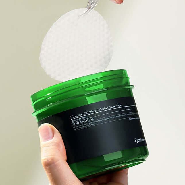 PYUNKANG YUL Ultimate Soothing Solution Toner Pads 70 sheets 140ml being removed from green container.