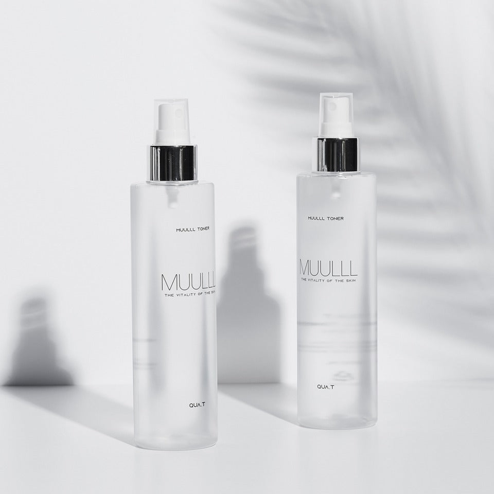 QUA-T Petavegan Large Capacity Toner 300ml bottles, displayed on a light surface with shadows.