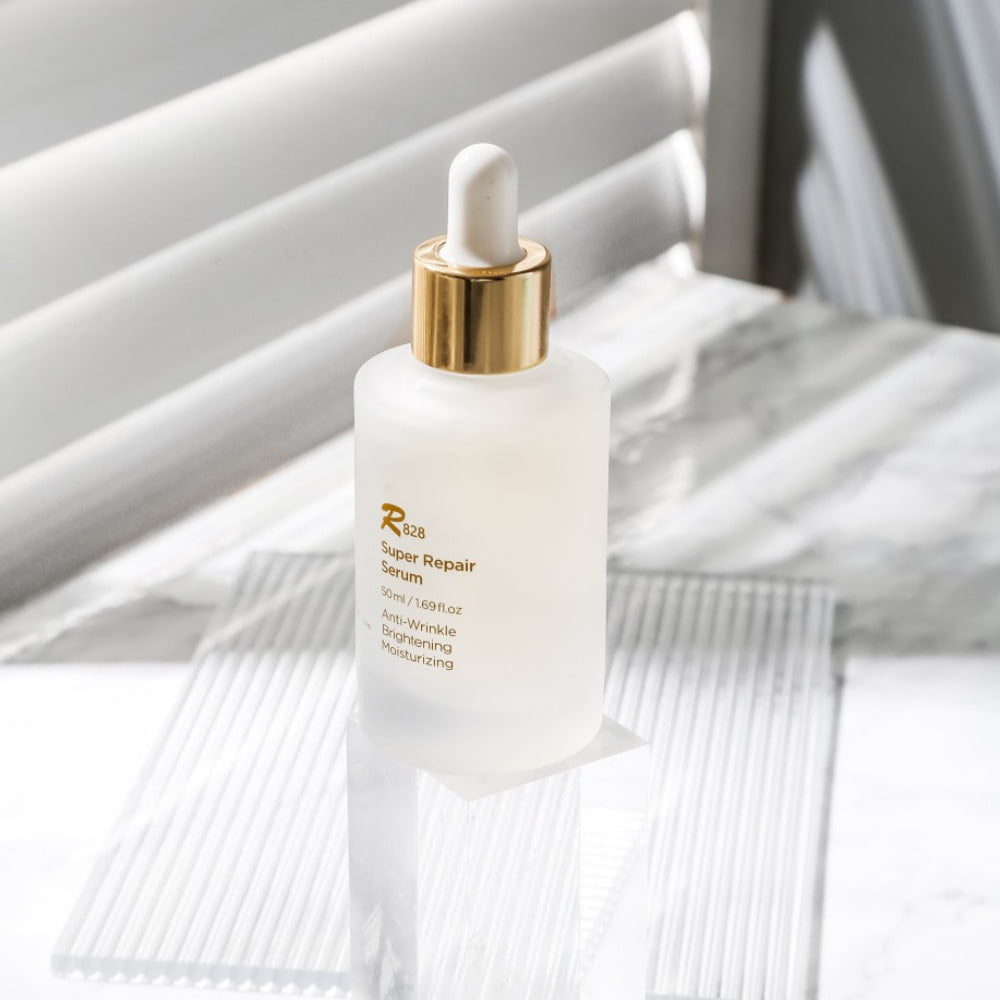 R828 Super Repair Serum 50ml bottle on a white background with a dropper, highlighting its anti-wrinkle and moisturizing benefits.