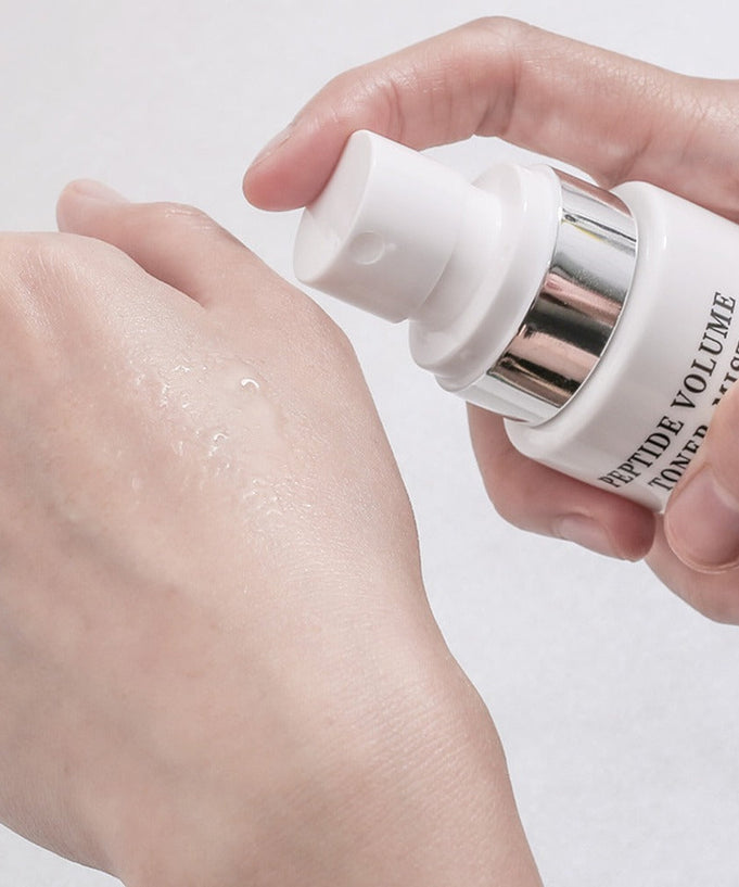 Applying R828 Peptide Volume Toner Mist onto skin for hydration and rejuvenation