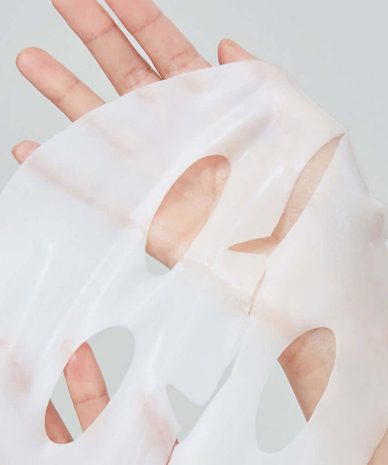 Hand holding REAL BARRIER Retinol Pore Tightening Serum Gel Mask x5 Sheets, showcasing translucent mask texture.