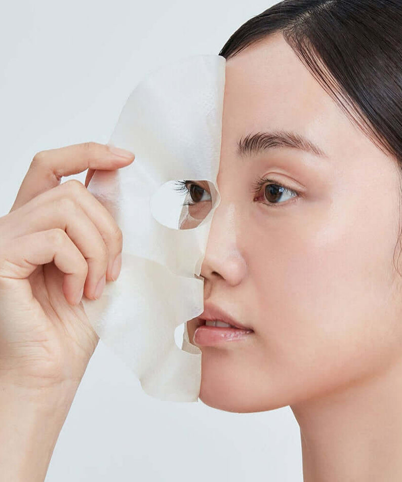 Woman applying REAL BARRIER Retinol Pore Tightening Serum Gel Mask x5 Sheets for skincare routine