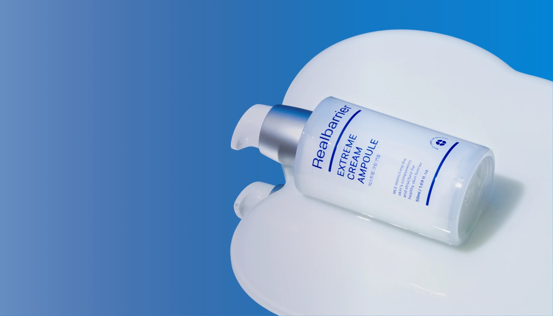 Real Barrier Extreme Cream Ampoule on a white and blue background