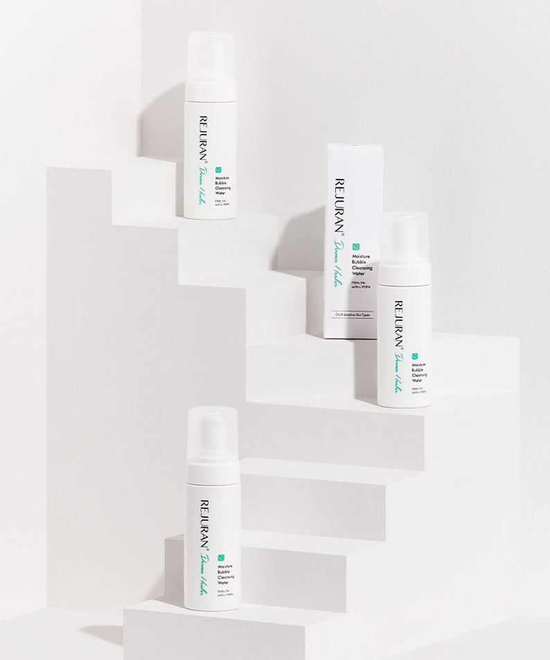 REJURAN Derma Healer Moisture Bubble Cleansing Water 150ml bottles displayed on a white stepped platform