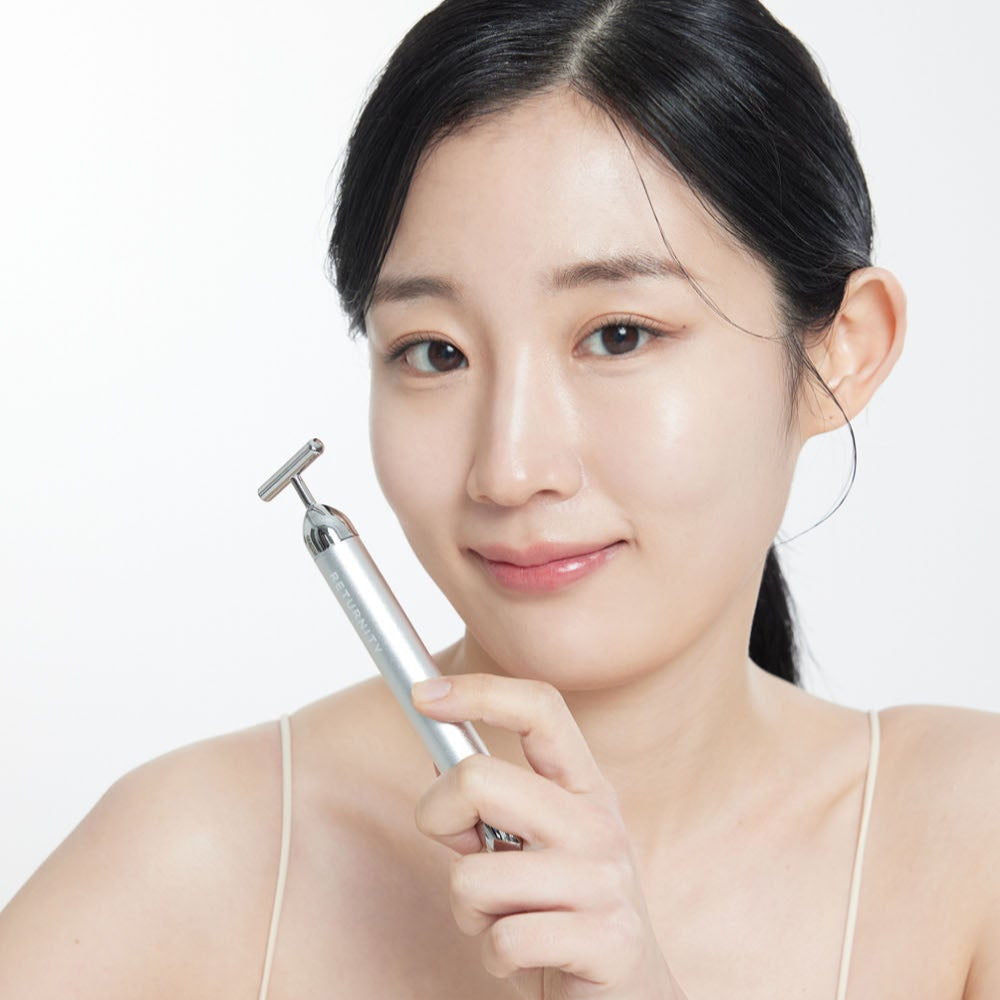 Woman holding a massage device for skin care