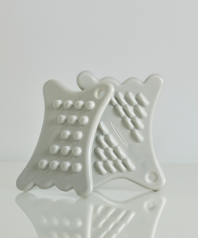 RETURNITY Mini Guasha tool with textured design for massage and skincare.