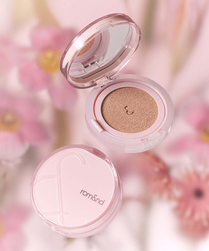 ROMAND Bloom in Coverfit Cushion with pink floral background, featuring compact design and smooth texture