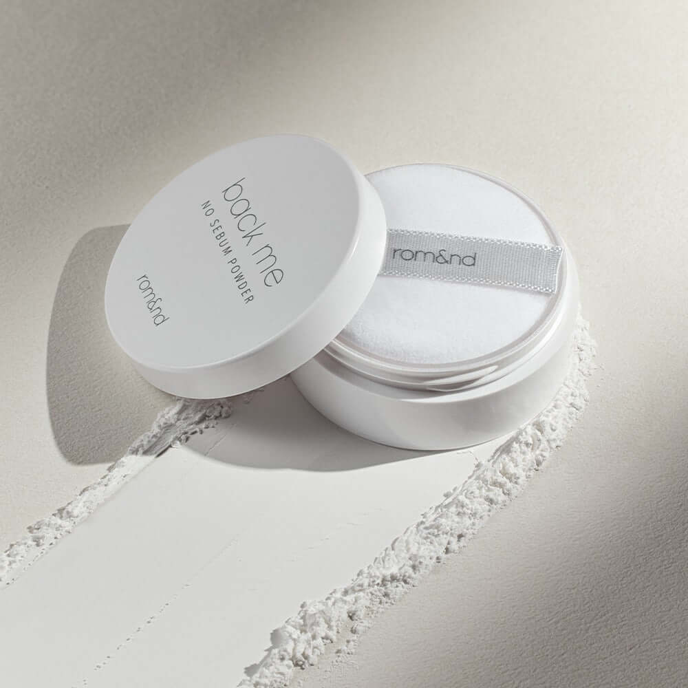 ROMAND White Rice No Sebum Powder container and puff on textured surface