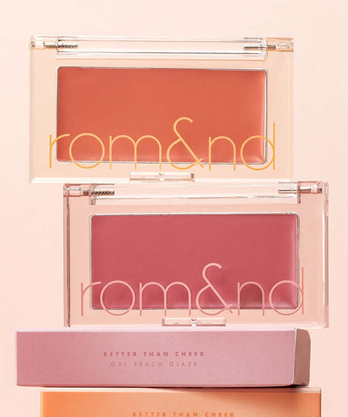 ROMAND better than cheek #glaze blushes displayed with packaging, highlighting the peach and pink shades.