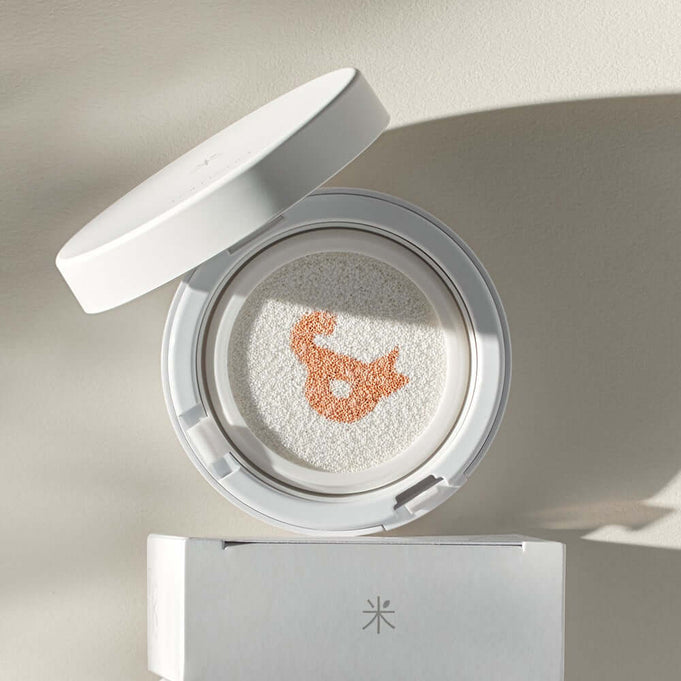 ROMAND white me tone up sun cushion displayed with open lid, showcasing unique pattern and highlighting SPF benefits.