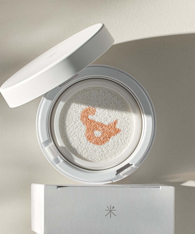 ROMAND white me tone up sun cushion displayed with open lid, showcasing unique pattern and highlighting SPF benefits.