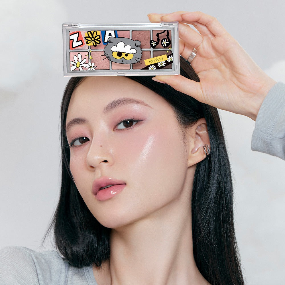 Woman holding ROMAND x Joanne Friends Better Than Palette showcasing eyeshadow colors