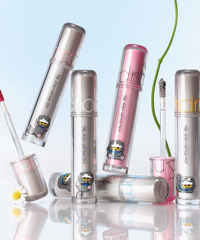 ROMAND x Joanne Friends The Juicy Lasting Tint lipsticks display with floral elements