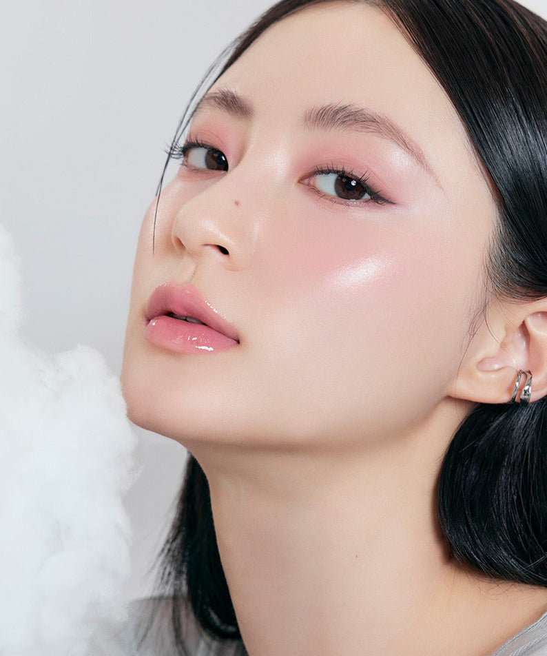 Model wearing ROMAND x Joanne Friends The Juicy Lasting Tint, showcasing a dewy makeup look with glossy lips and soft eye makeup.