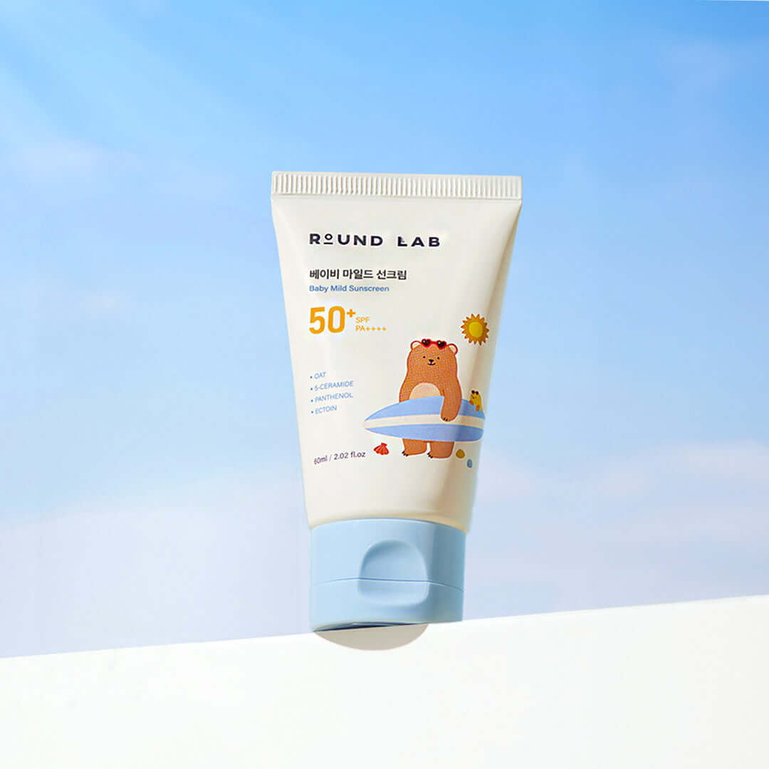ROUND LAB Baby Mild Sun Cream 60ml with SPF 50 packaging against a blue sky background