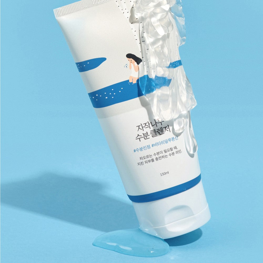 ROUND LAB Birch Juice Moisturizing Cleanser 150ml on a blue background with clear liquid, 150ml tube