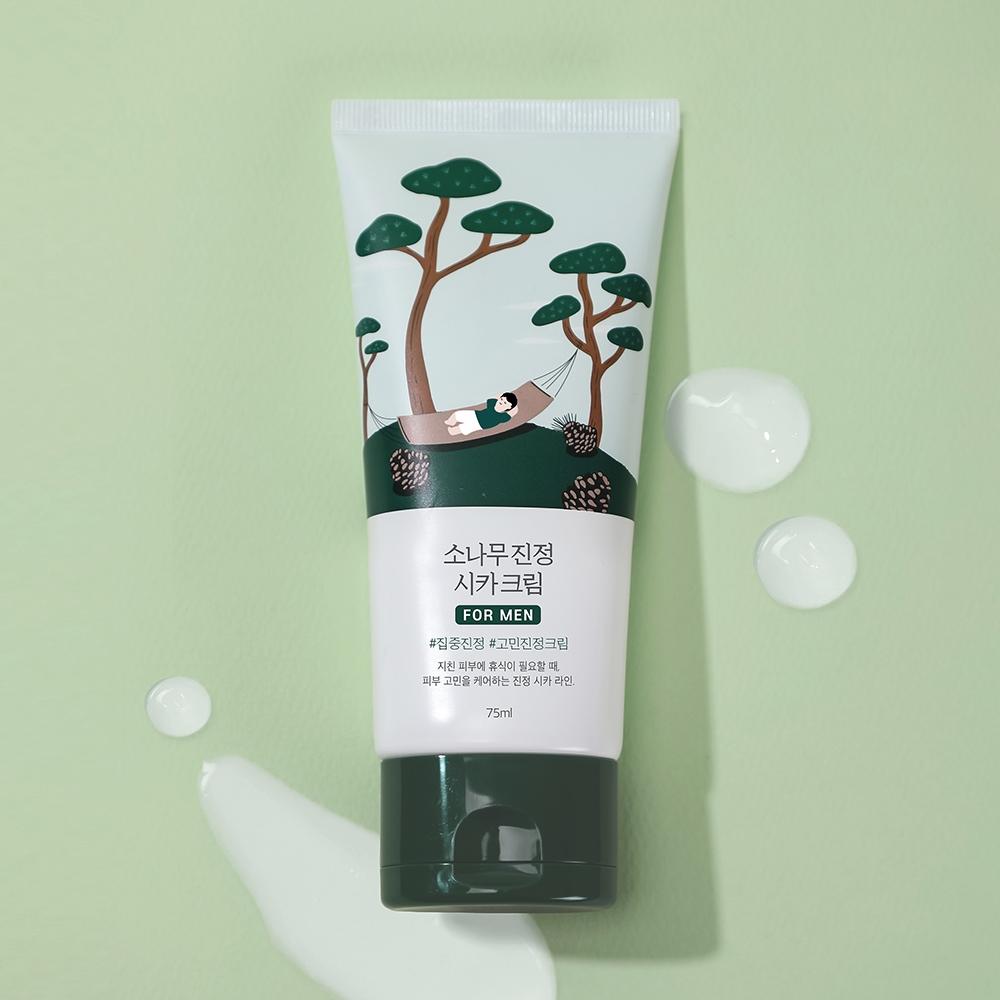 ROUND LAB For Men Pine Calming Cica Cream 75ml tube on green background with cream drops, Gentleman Korea men's soothing skincare product