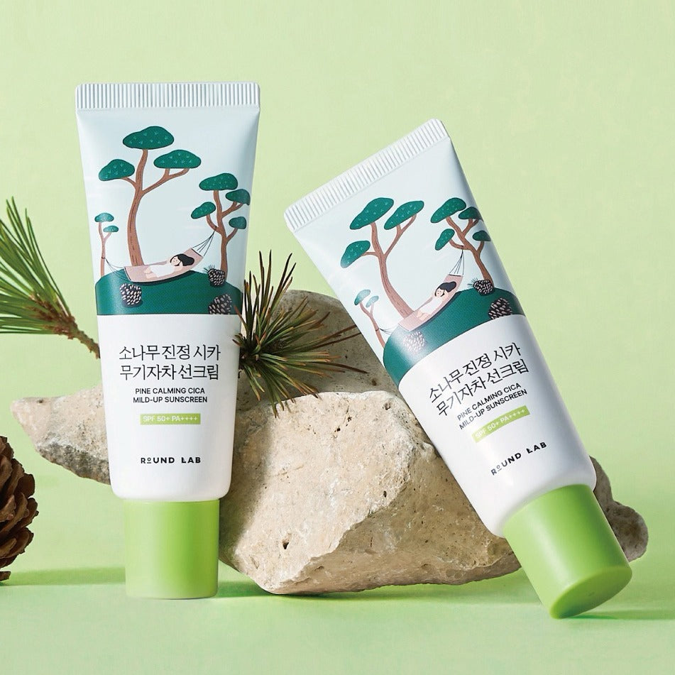 ROUND LAB Pine Tree Calming Cica Mineral Sunscreen 40ml tubes on rock and green background