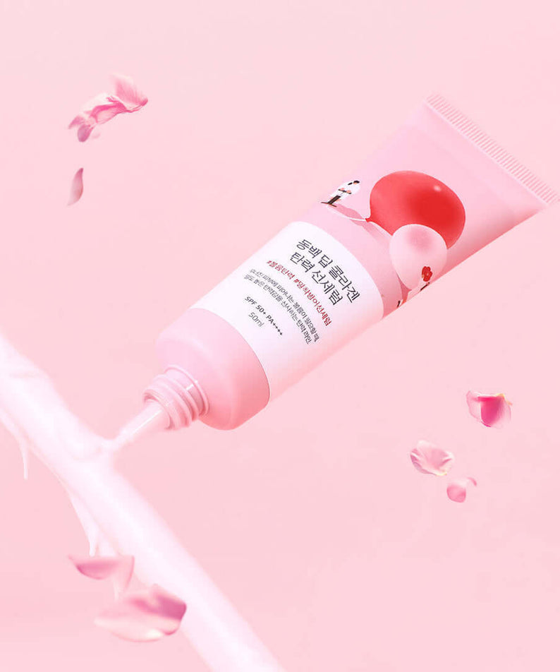 ROUND LAB Dongbaek Deep Collagen Elasticity Sun Serum 50ml with floral design on a pink background