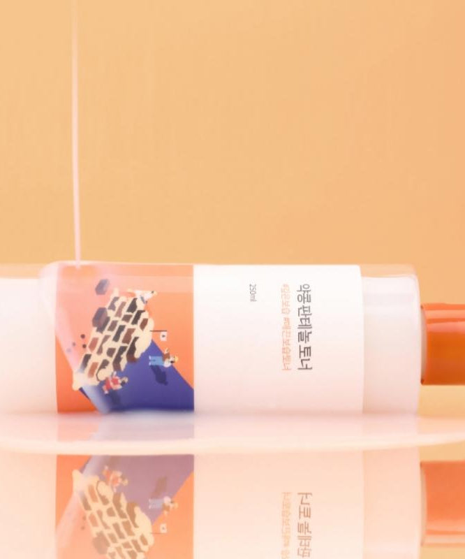 ROUND LAB Yakkong Panthenol Toner 250ml on a reflective surface with peach background