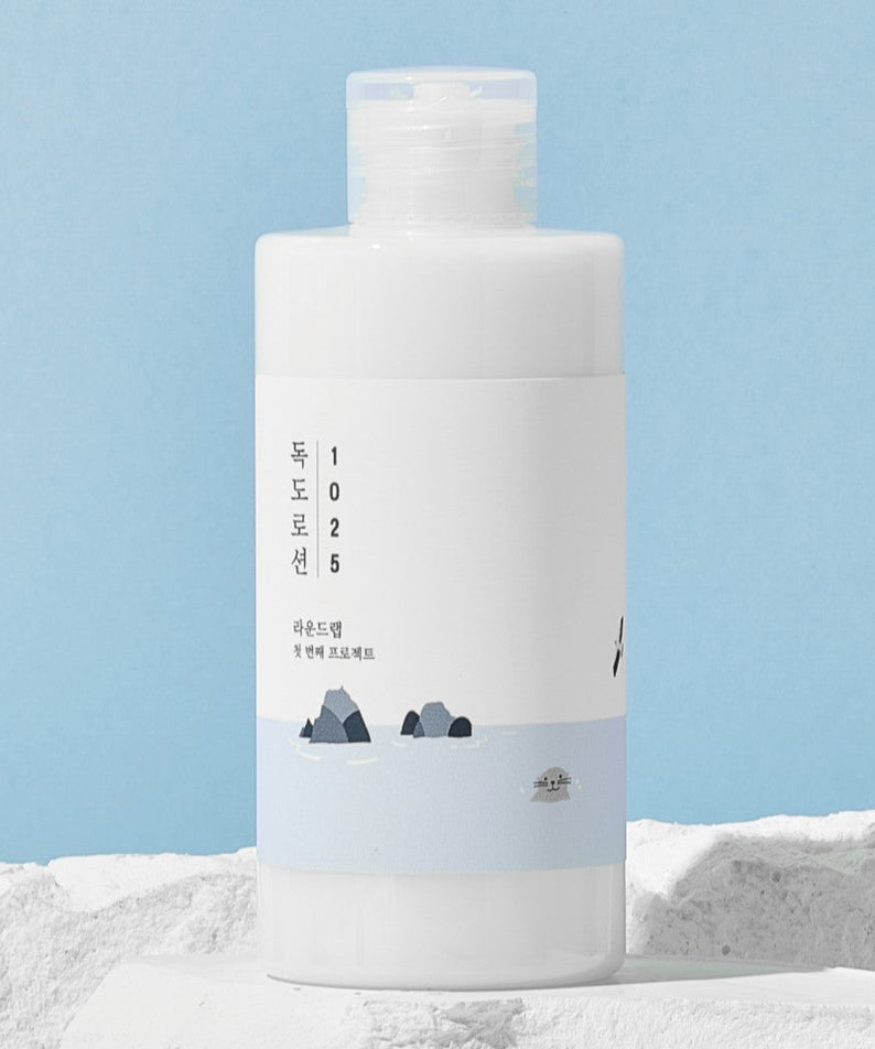 Image of ROUND LAB 1025 Dokdo Lotion 200ml with a minimalistic design and blue accents against a textured background.