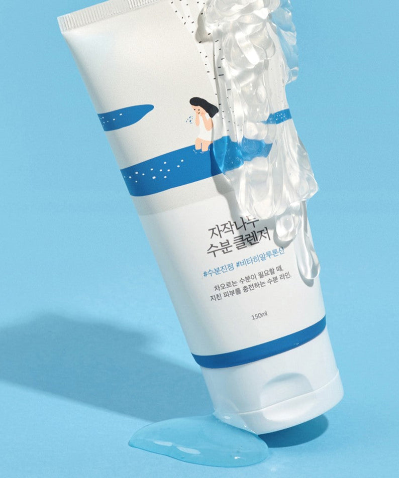 ROUND LAB Birch Juice Moisturizing Cleanser 150ml on a blue background with clear liquid, 150ml tube