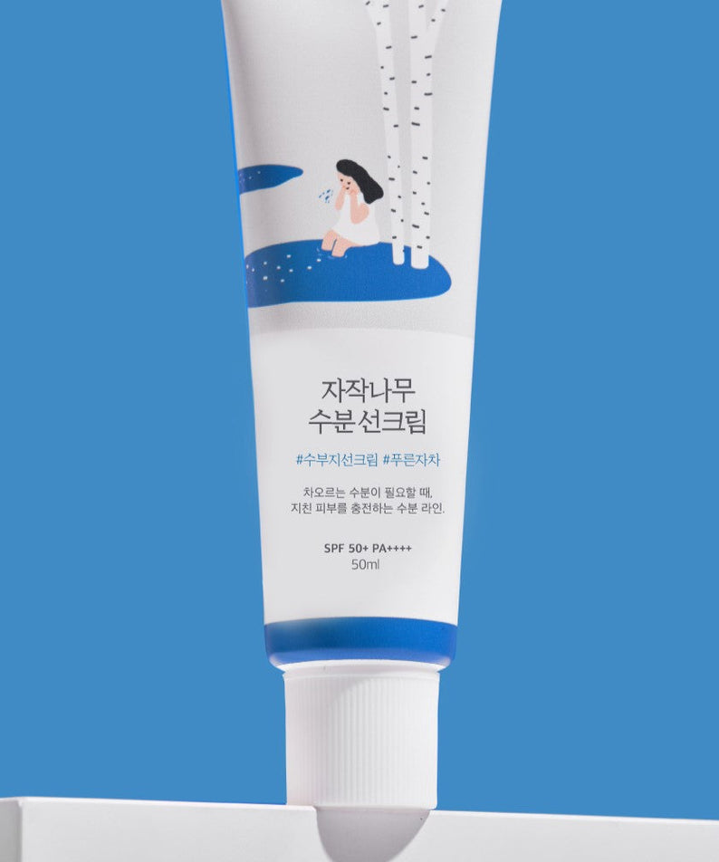 ROUND LAB Birch Juice Moisturizing Sunscreen 50ml on blue background