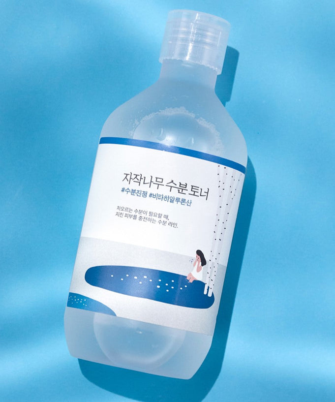 Image of ROUND LAB Birch Juice Moisturizing Toner 300ml bottle on a blue background.