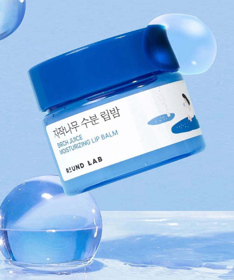Image of ROUND LAB Birch Moisture Lip Balm 20g in blue packaging against a blue background.