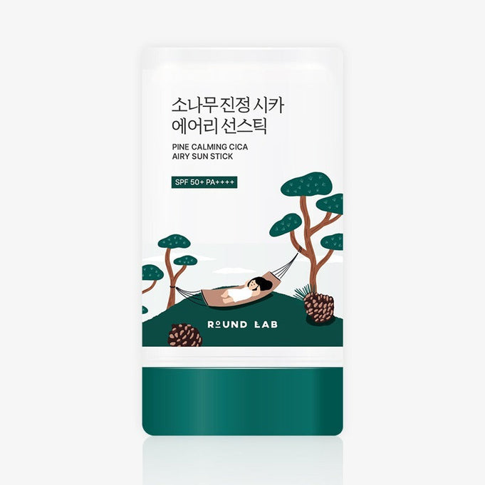 Packaging of ROUND LAB Pine Soothing Cica Airy Sun Stick 19g with illustration of a person relaxing in a hammock among pine trees.