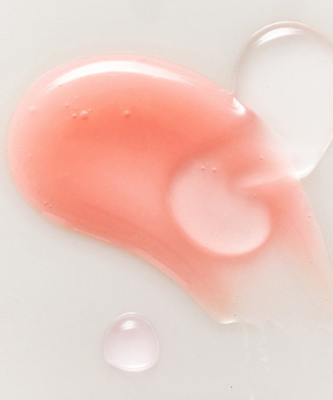 Texture of RULIDIA Shining Moment Caring Lip Balm 8g showing pink and clear gloss on a white surface.