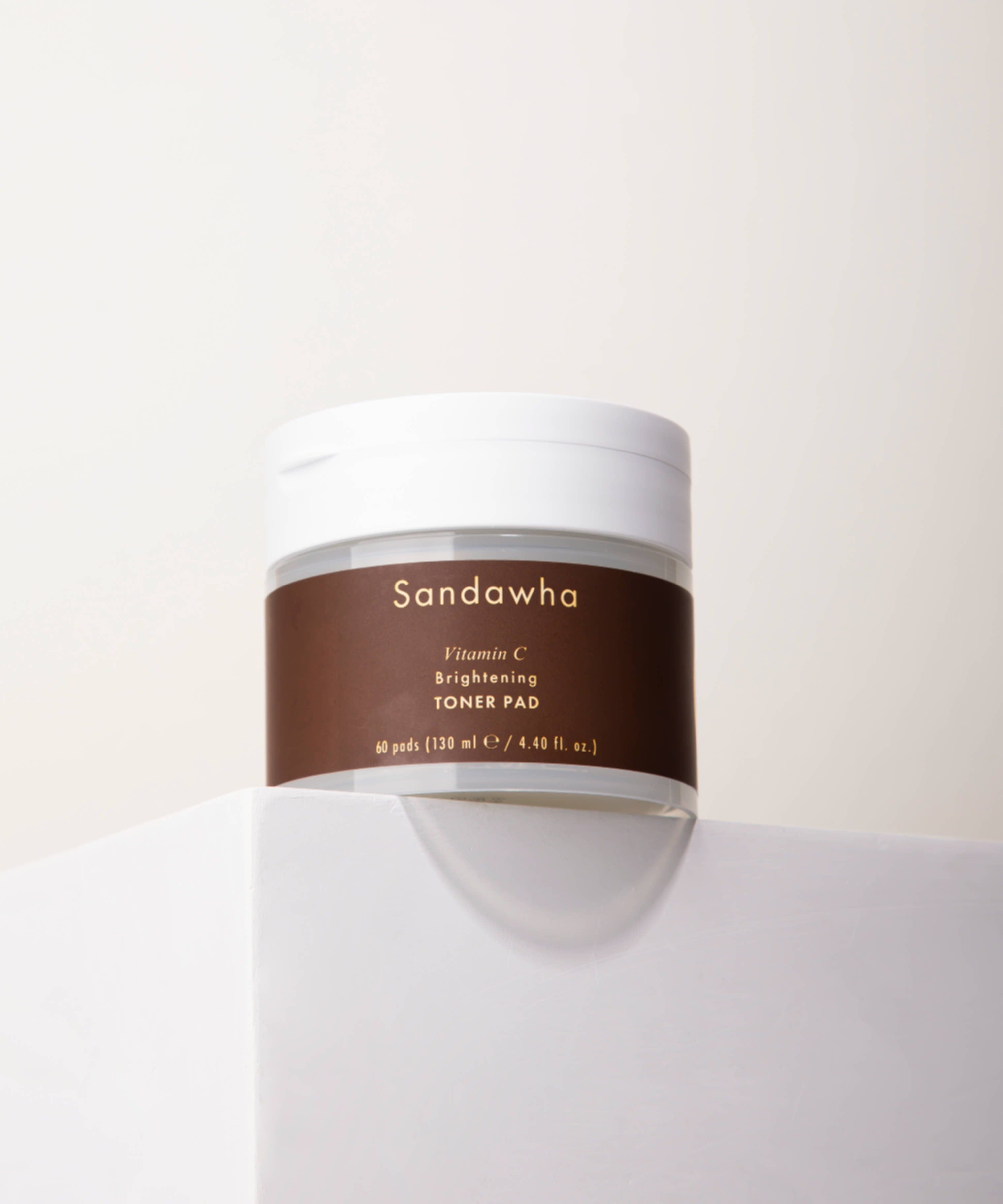 SANDAWHA Vitamin C Whitening Toner pad 60 Sheets in a sleek jar placed on a white surface, skincare product for brightening