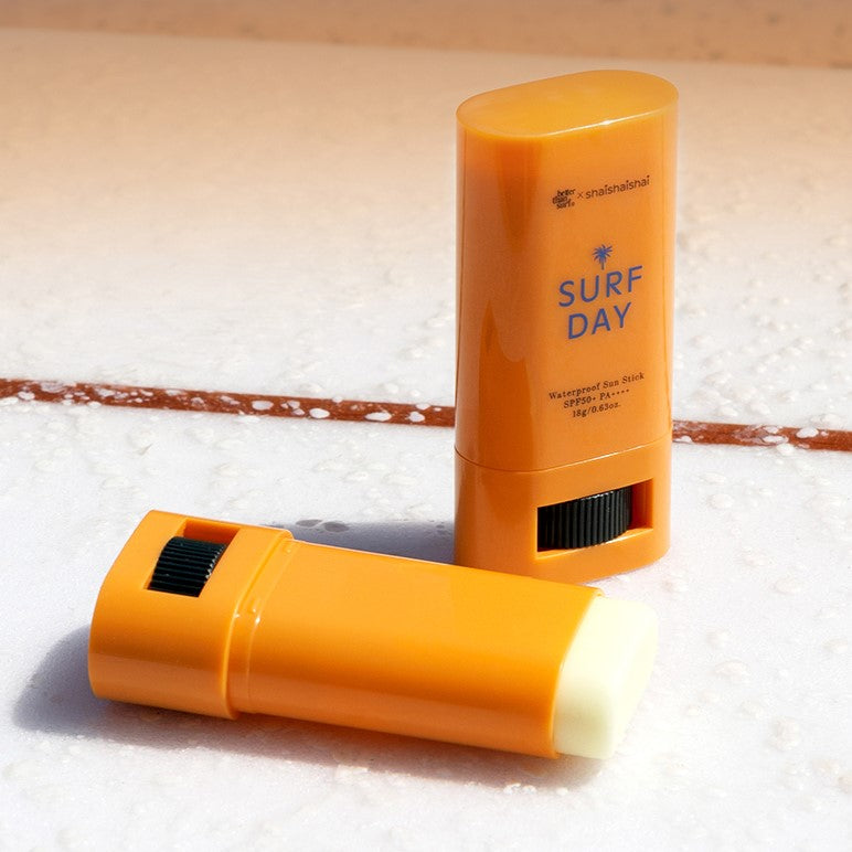 SHAISHAISHAI Surf Day Waterproof Sun Stick SPF50+ PA++++ 18g on sandy beach surface