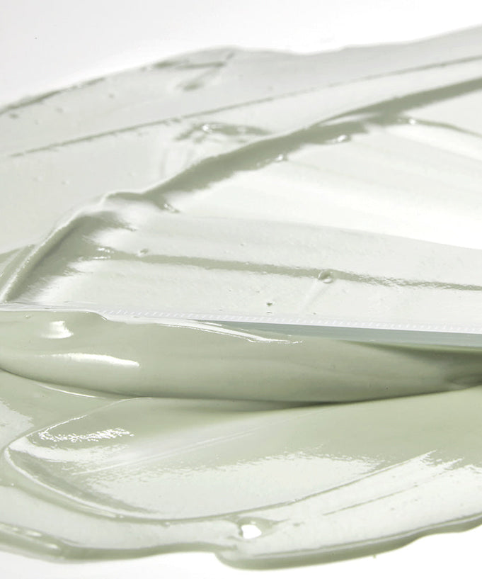 Texture of SHAISHAISHAI [1+1]Aloe PDRN Cooling Mud Mask 100ml cream spread with a spatula, showing smooth and creamy consistency.