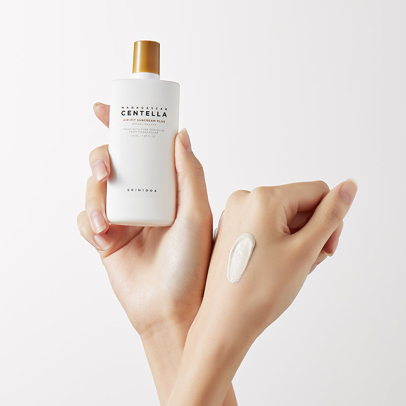 Close-up of hands holding SKIN1004 Madagascar Centella Air-fit Sunscreen Plus 50ml showing texture.