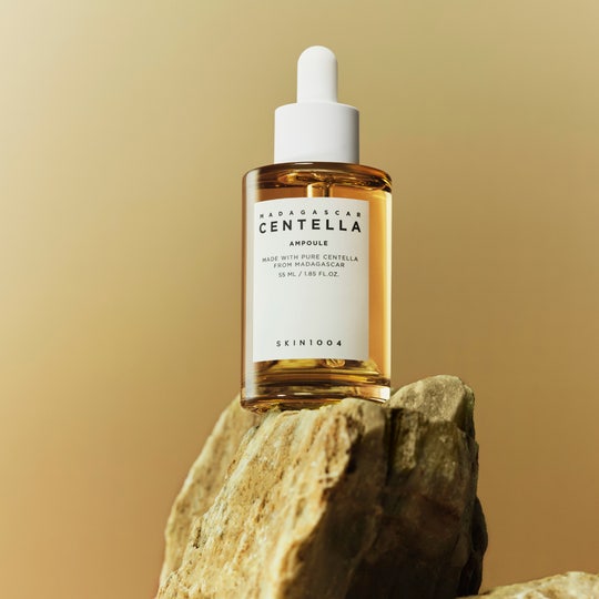 SKIN1004 Madagascar Centella Ampoule 55ml bottle displayed on a rock surface.