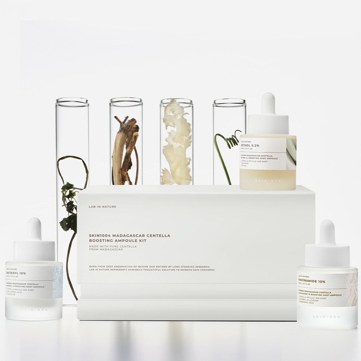 Image of SKIN1004 Madagascar Centella Boosting Ampoule Kit with ampoules and ingredients display.