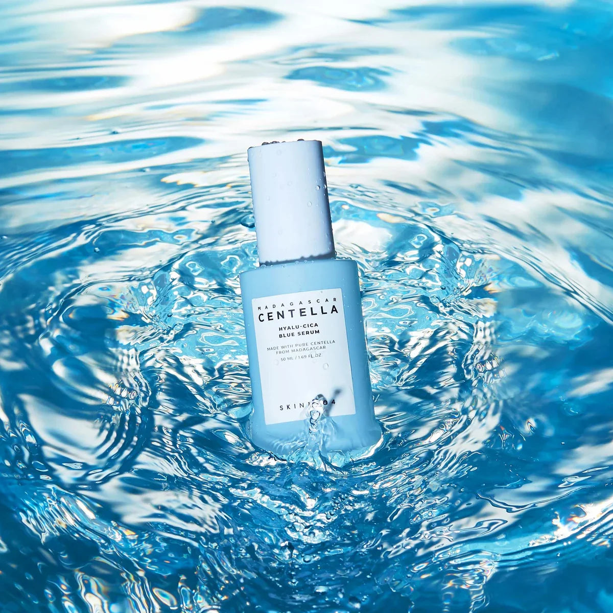 SKIN1004 Madagascar Centella Hyalu-Cica Blue Serum 50ml bottle in a splash of water