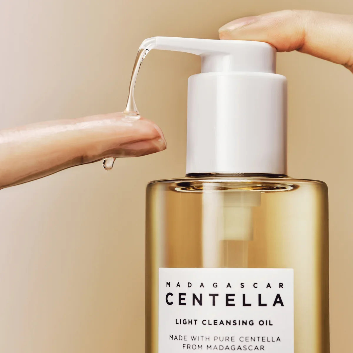 SKIN1004 Madagascar Centella Light Cleansing Oil 200ml bottle with pump dispensing oil on fingertip