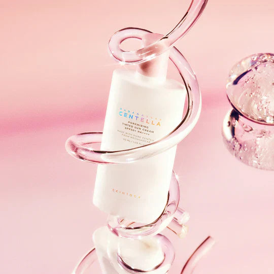 SKIN1004 Madagascar Centella Poreizing Velvet Finish Sunscreen 50ml displayed in a pink background with a decorative design.