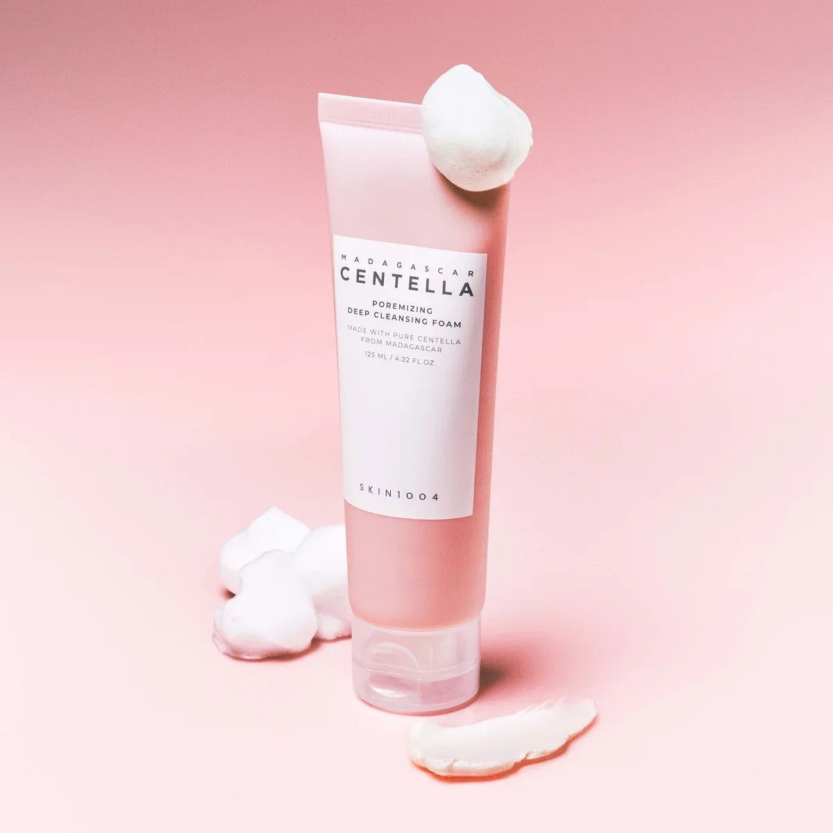 SKIN1004 Madagascar Centella Poremizing Deep Cleansing Foam 125ml on pink background with foam accents.