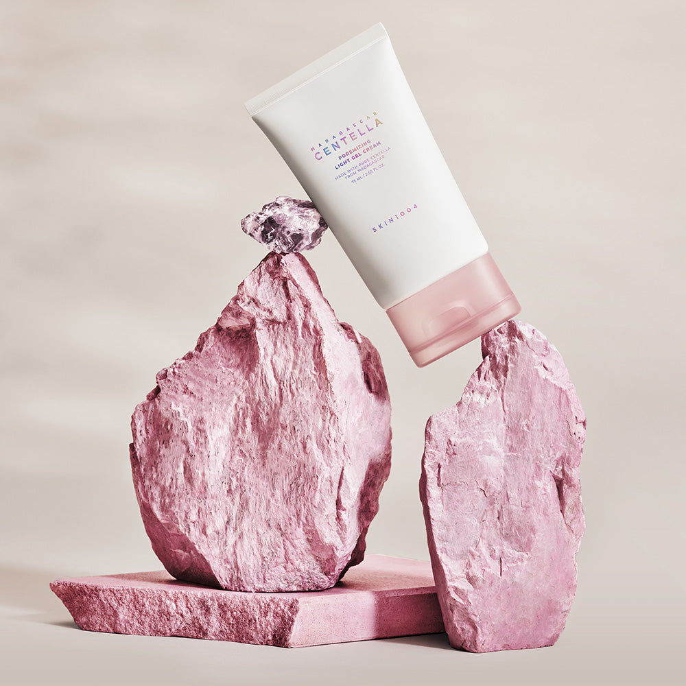 SKIN1004 Madagascar Centella Poremizing Light Gel Cream 75ml displayed on pink stones for skincare promotion.