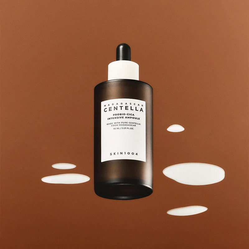 SKIN1004 Madagascar Centella Probio-cica Intensive Ampoule 50ml bottle with splashes on a brown background.