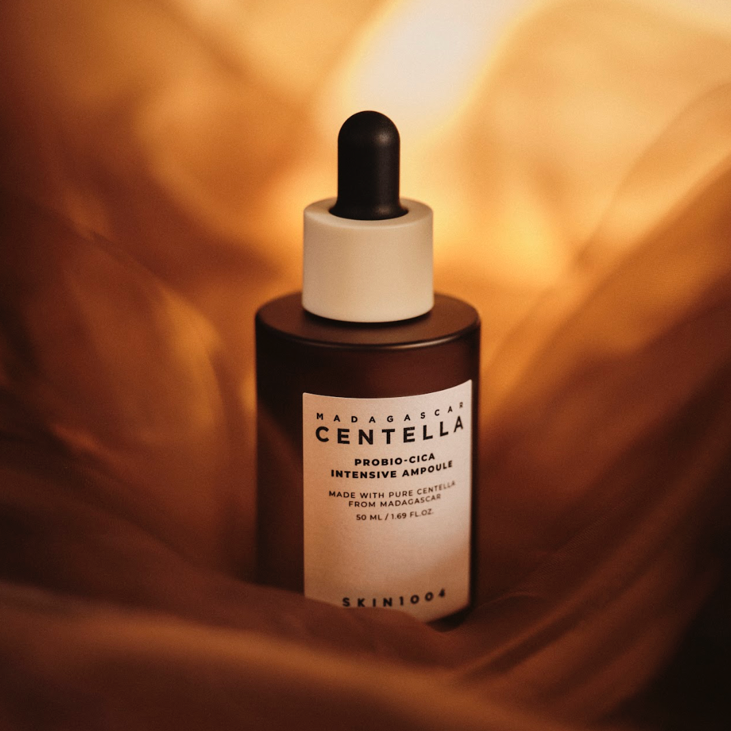 SKIN1004 Madagascar Centella Probio-cica Intensive Ampoule 95ml bottle on a soft brown fabric background.