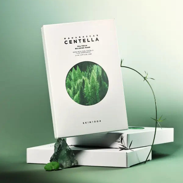 SKIN1004 Madagascar Centella Tea-trica Relaxing Mask 24ml [5 sheets] packaging displayed on a green background.