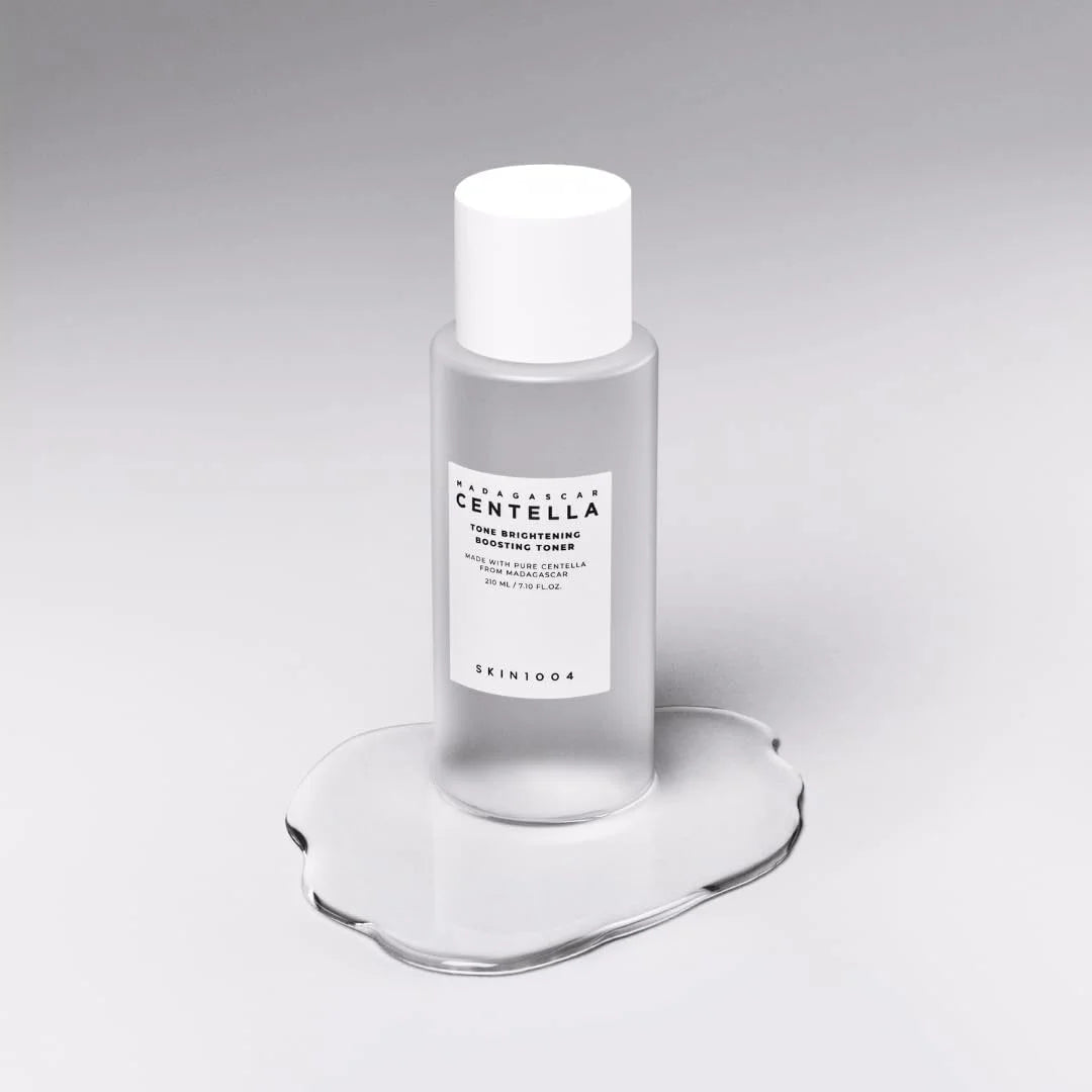 SKIN1004 Madagascar Centella Tone Brightening Boosting Toner 210ml bottle on a reflective surface.