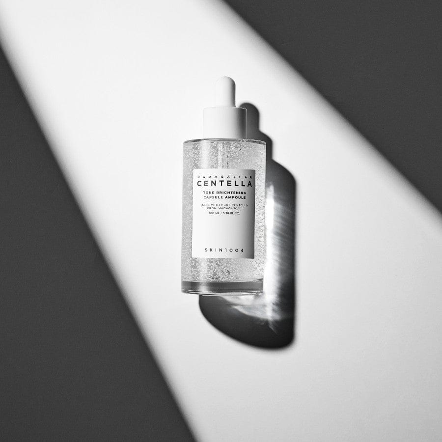 SKIN1004 Madagascar Centella Tone Brightening Capsule Ampoule 100ml bottle on a white and gray background.