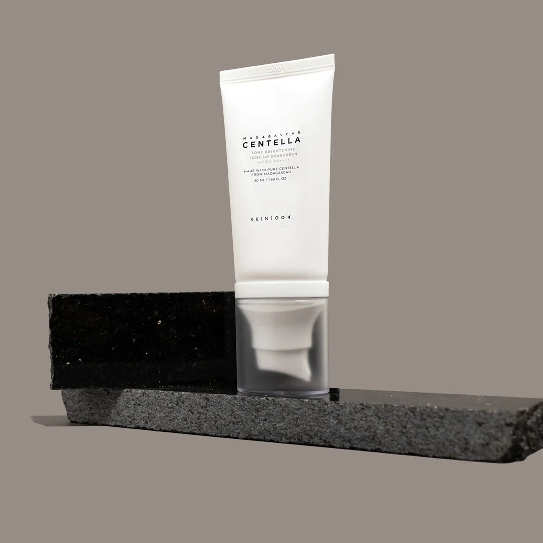 SKIN1004 Madagascar Centella Tone Brightening Tone-Up Sunscreen 50ml product display on modern stone background
